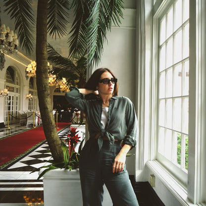 Green linen top and pants in hotel lobby